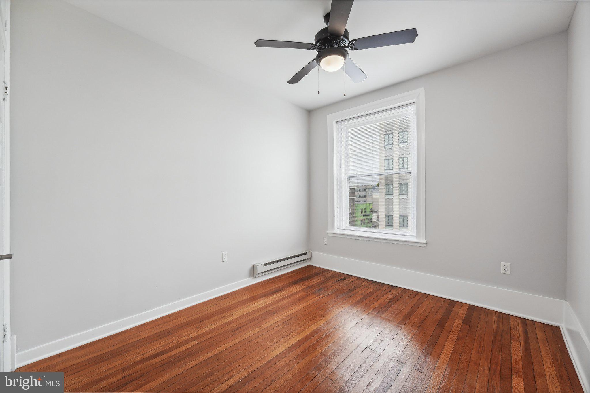 4300 Chestnut Street, Unit 1 Philadelphia, PA 19104 - Photo 18 of 30 wooden floor in an empty room with a window