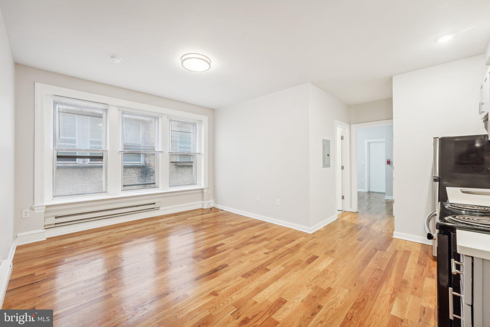 4300 Chestnut Street, Unit 1 Philadelphia, PA 19104 - Photo 22 of 30 a view of a livingroom with wooden floor and a flat screen tv