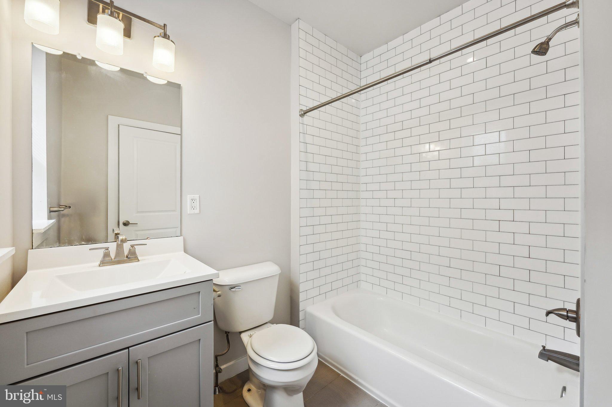 4300 Chestnut Street, Unit 1 Philadelphia, PA 19104 - Photo 24 of 30 a bathroom with a sink a toilet and shower