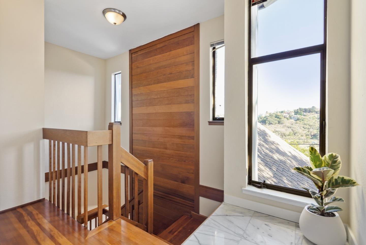 4015 Marsten Avenue Belmont, CA 94002 - Photo 37 of 53 a view of a hallway with wooden floor and a potted plant