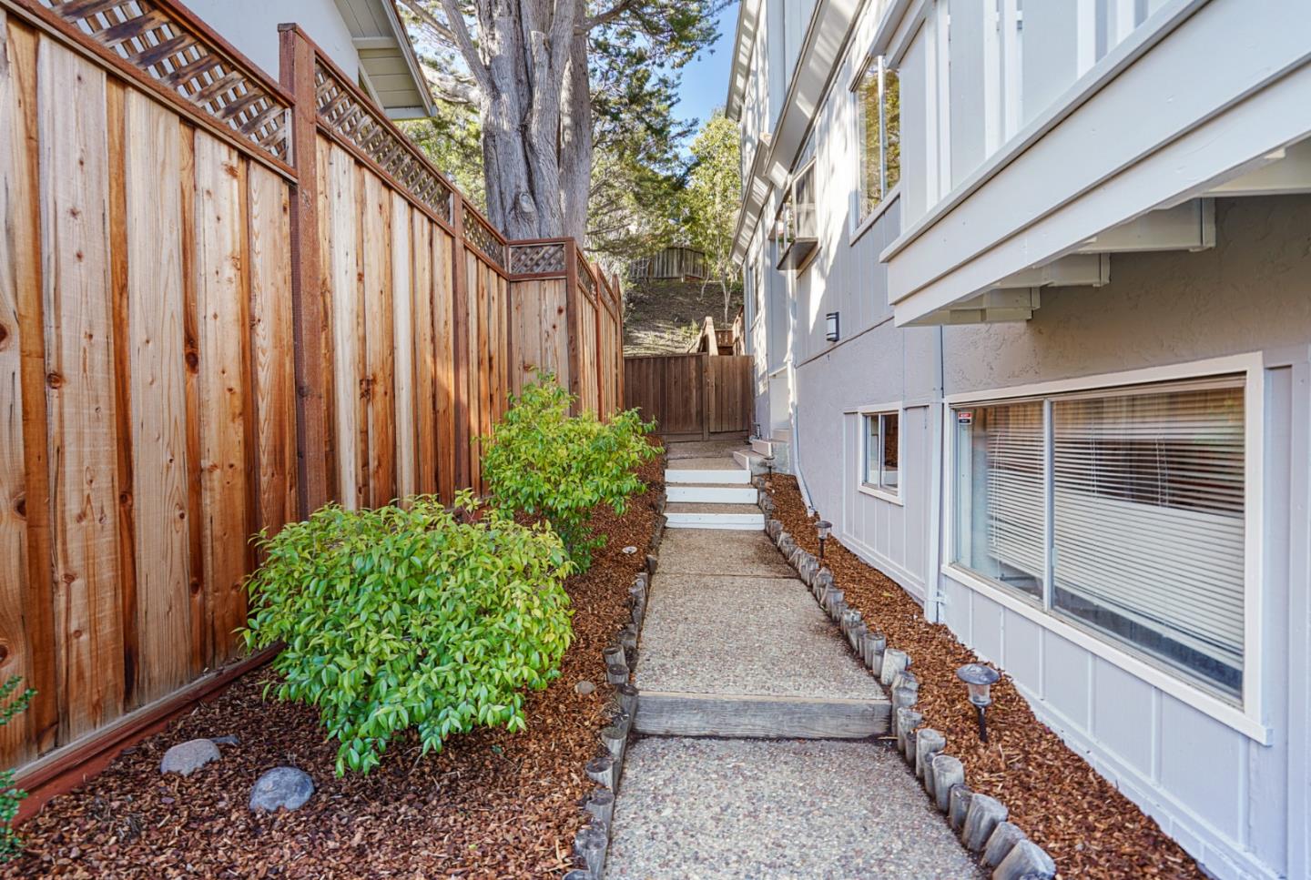 4015 Marsten Avenue Belmont, CA 94002 - Photo 4 of 53 a view of a pathway with house on both side