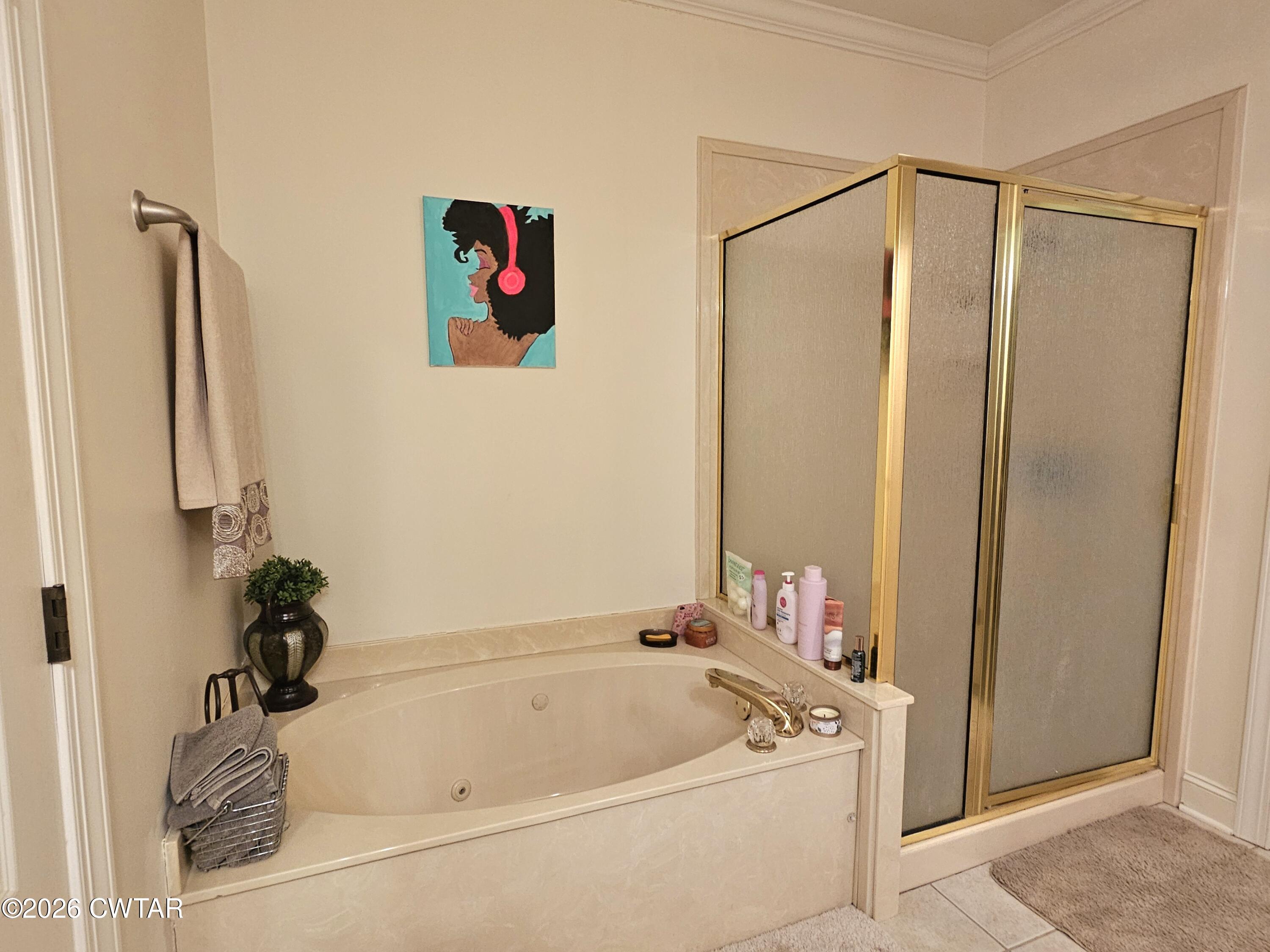 129 Quail Ridge Jackson, TN 38305 - Photo 16 of 35 a bathroom with a tub and a shower