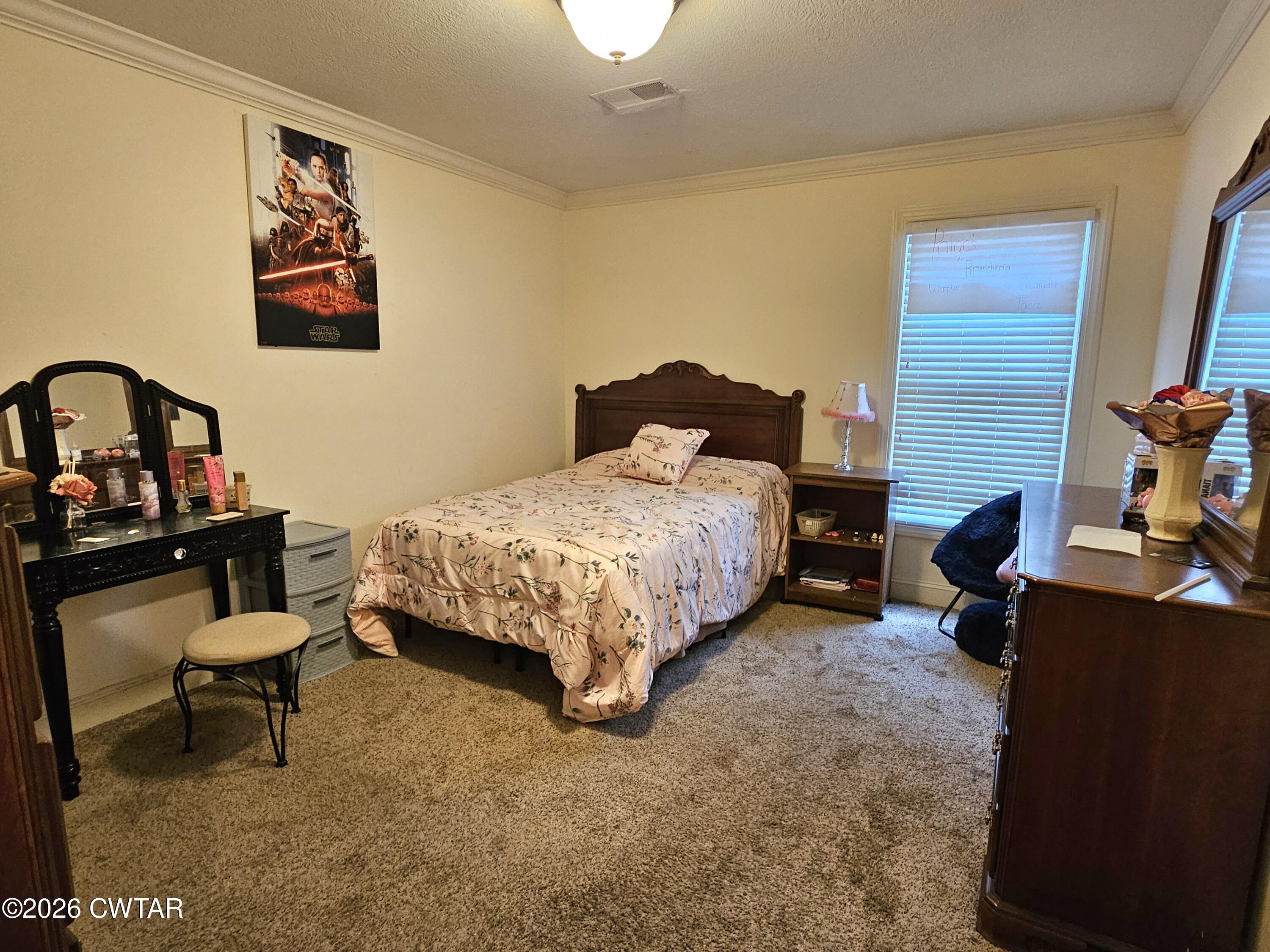 129 Quail Ridge Jackson, TN 38305 - Photo 19 of 35 a bedroom with a bed and a desk in it
