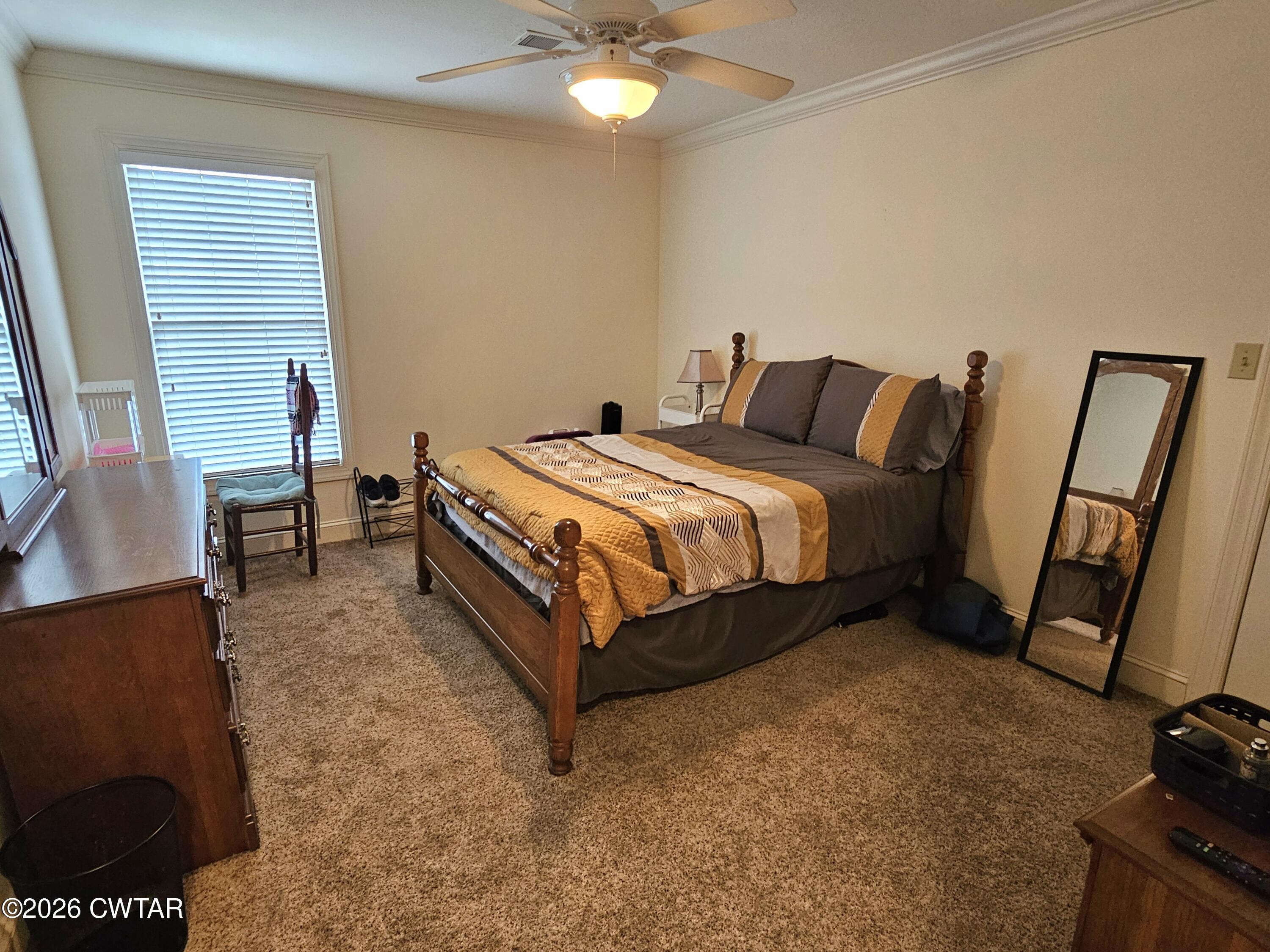 129 Quail Ridge Jackson, TN 38305 - Photo 21 of 35 a bed sitting in a bedroom next to a window