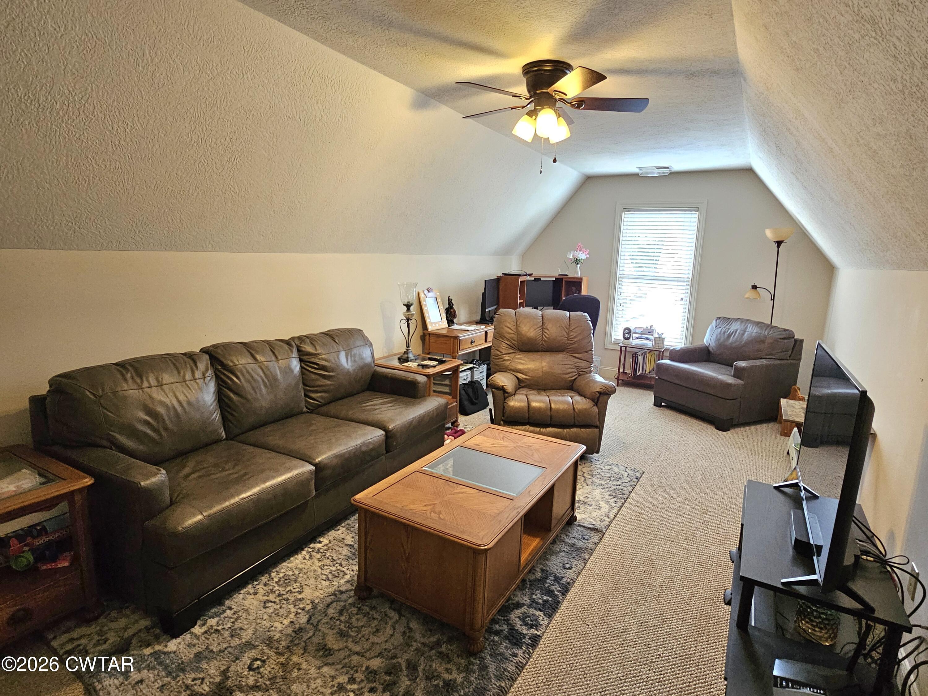 129 Quail Ridge Jackson, TN 38305 - Photo 22 of 35 a living room with furniture a ceiling fan and a rug