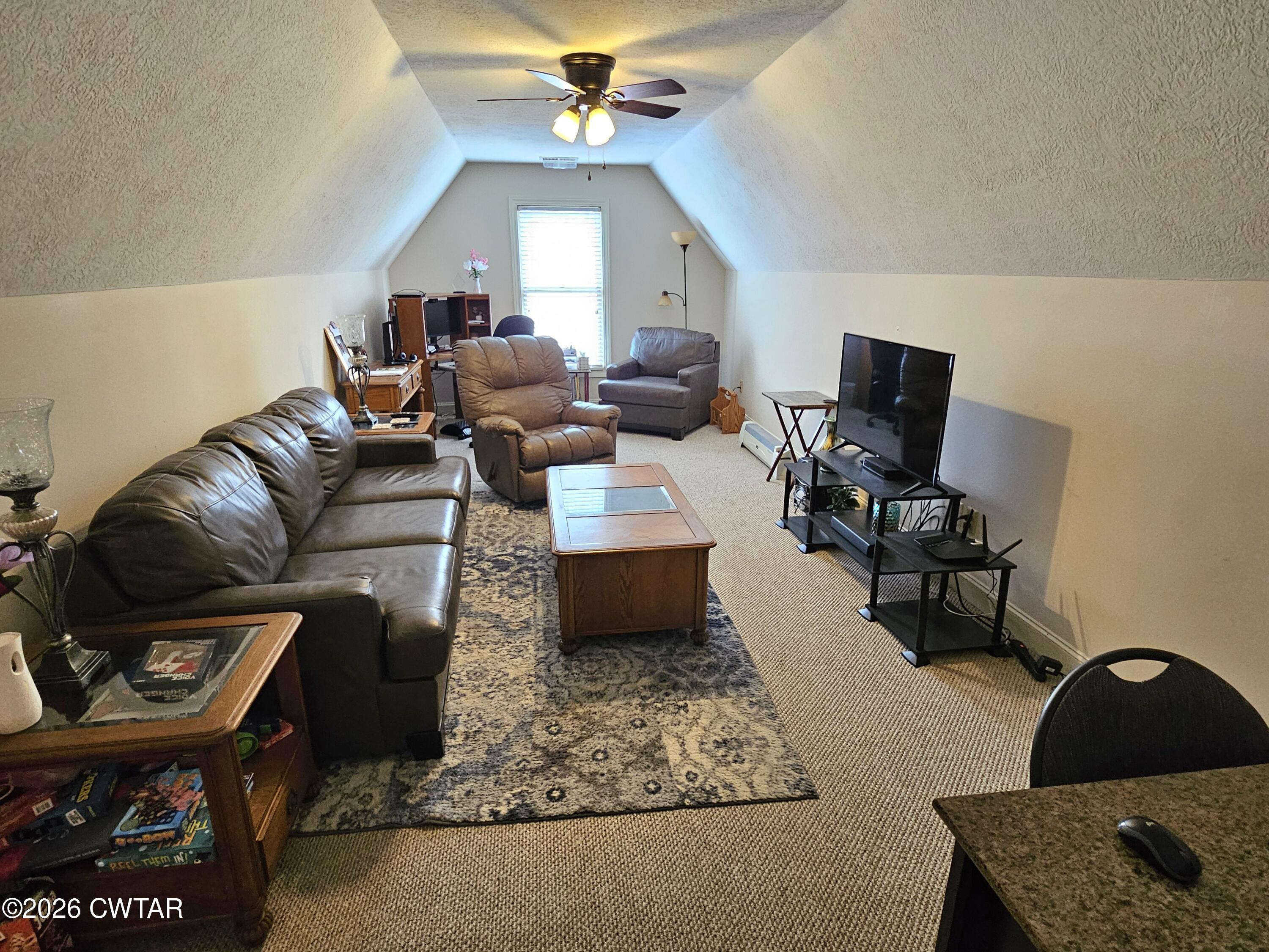 129 Quail Ridge Jackson, TN 38305 - Photo 23 of 35 a living room with furniture a chandelier and a window