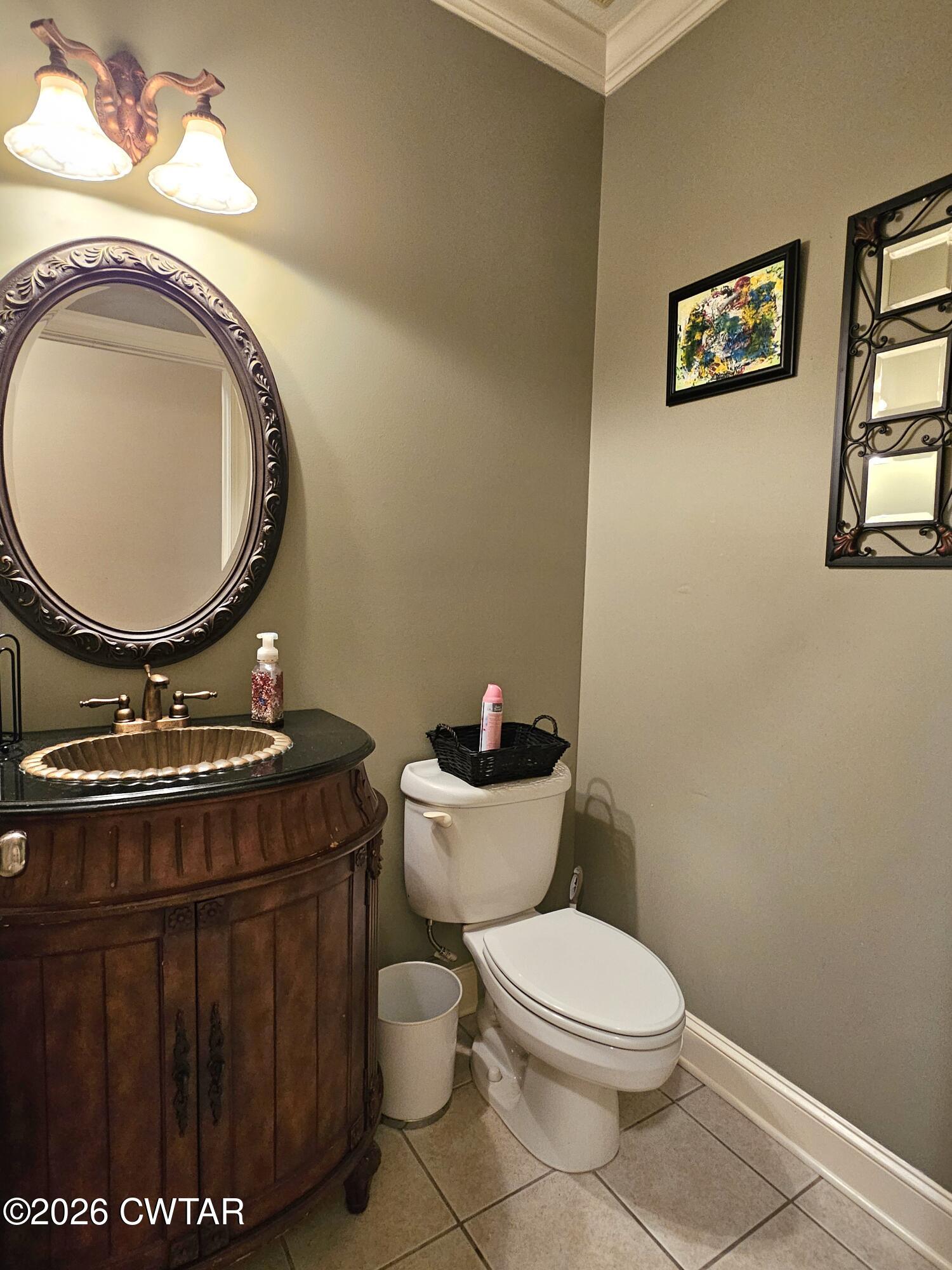 129 Quail Ridge Jackson, TN 38305 - Photo 24 of 35 a bathroom with a toilet a sink and a mirror