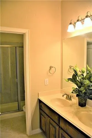 a bathroom with a sink a mirror and a shower