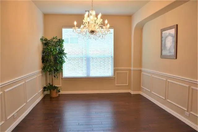 a view of a room with wooden floor and windows