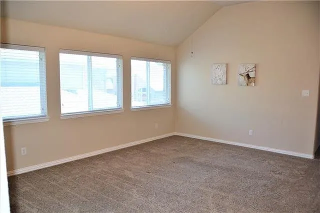 an empty room with windows and closet