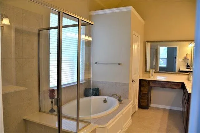 a bathroom with a tub and a shower