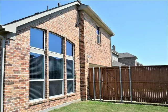 a view of a house with wooden fence