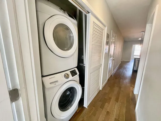a view of a hallway with washer and dryer