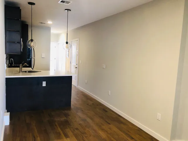 a bathroom with a sink a large mirror and a shower