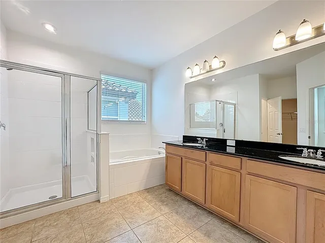 a large bathroom with a large tub sink and vanity