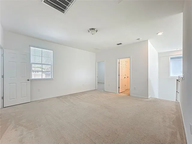 a view of an empty room with a window