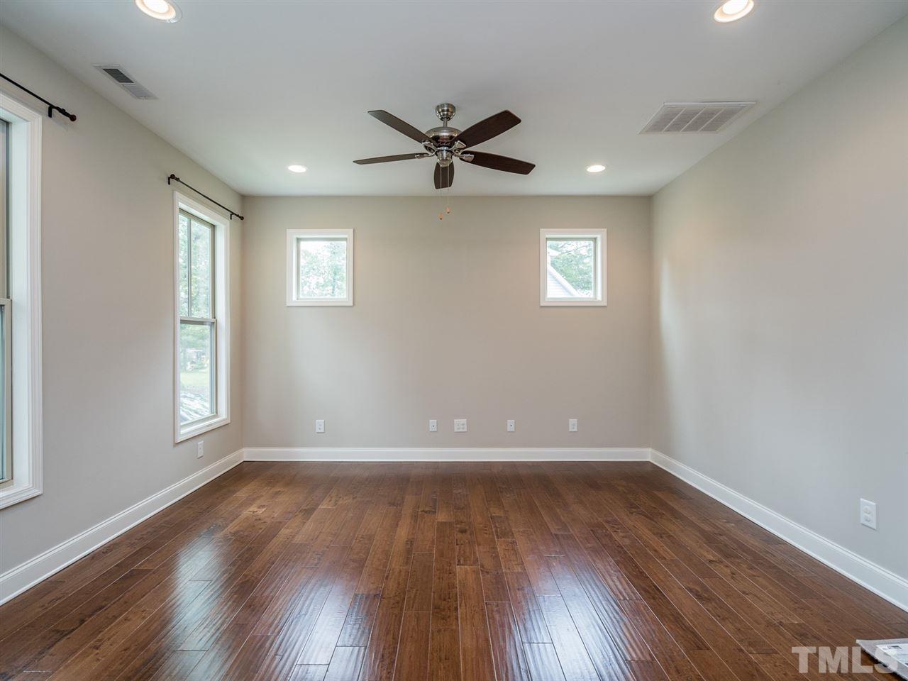 2308 Milburnie Road Raleigh, NC 27610 - Photo 4 of 25 a view of an empty room with wooden floor and a window