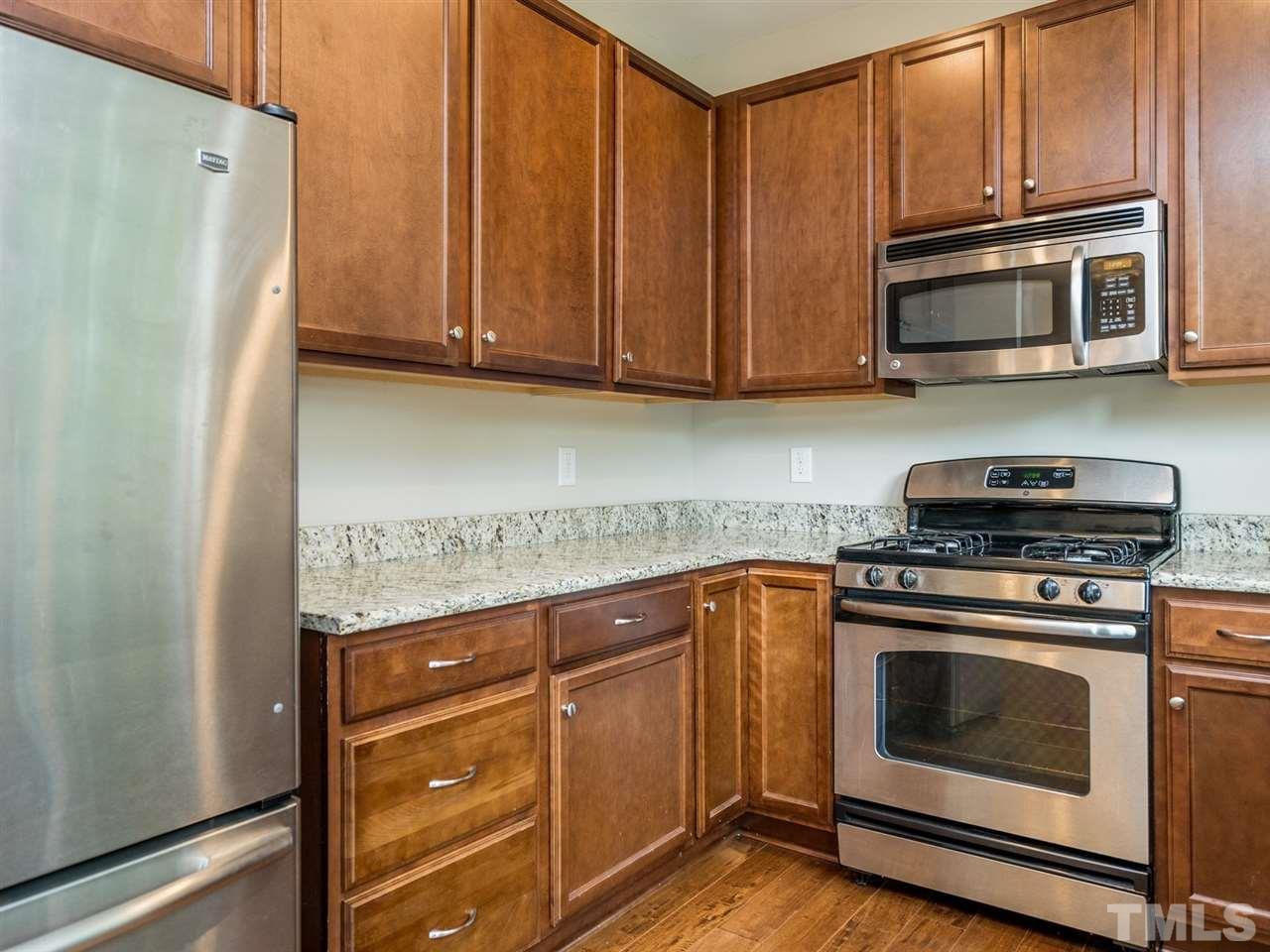 2308 Milburnie Road Raleigh, NC 27610 - Photo 9 of 25 a kitchen with stainless steel appliances granite countertop a refrigerator stove and microwave