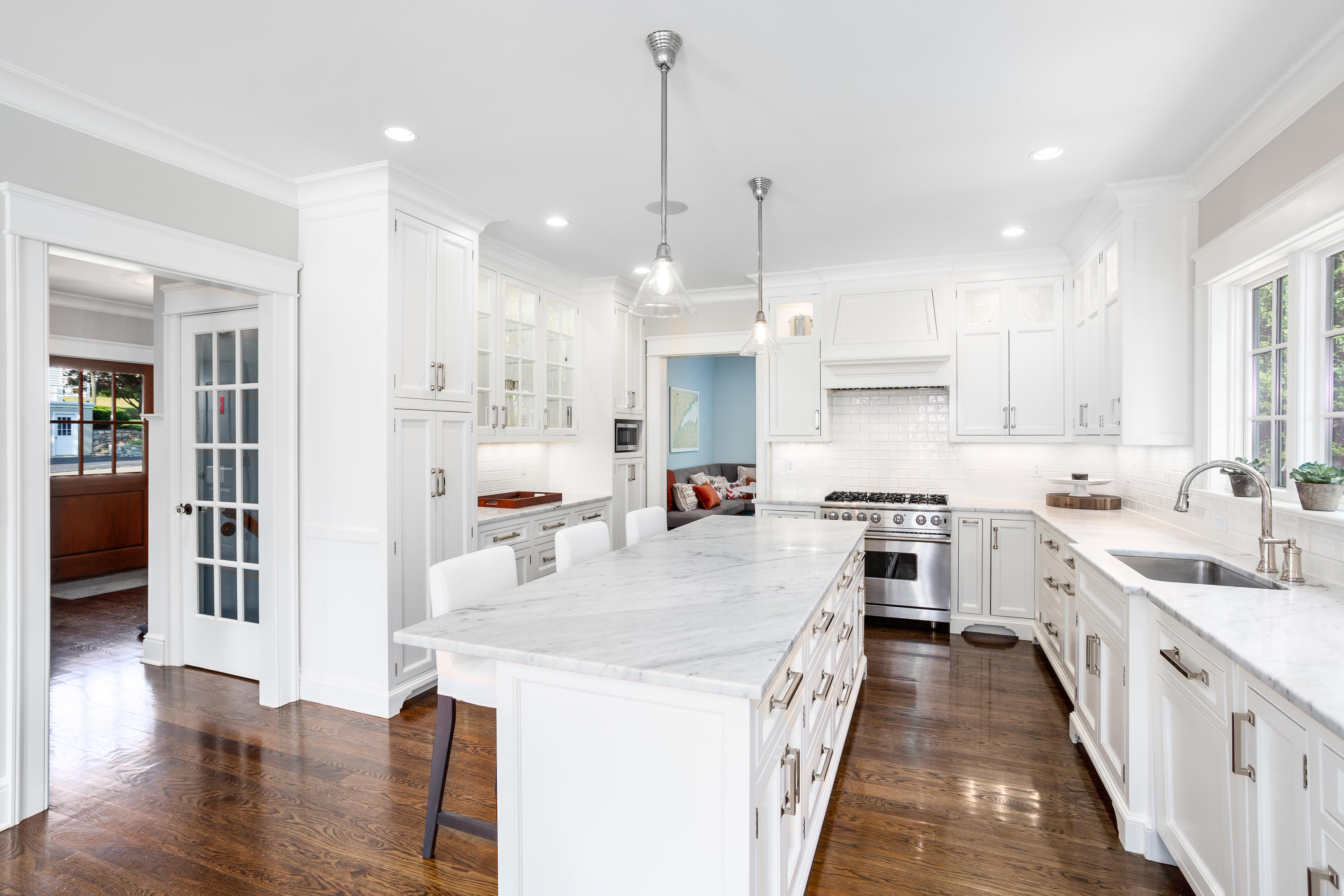 9 Concord Lane Darien, CT 06820 - Photo 11 of 36 a large kitchen with kitchen island a stove a sink a center island and wooden floor