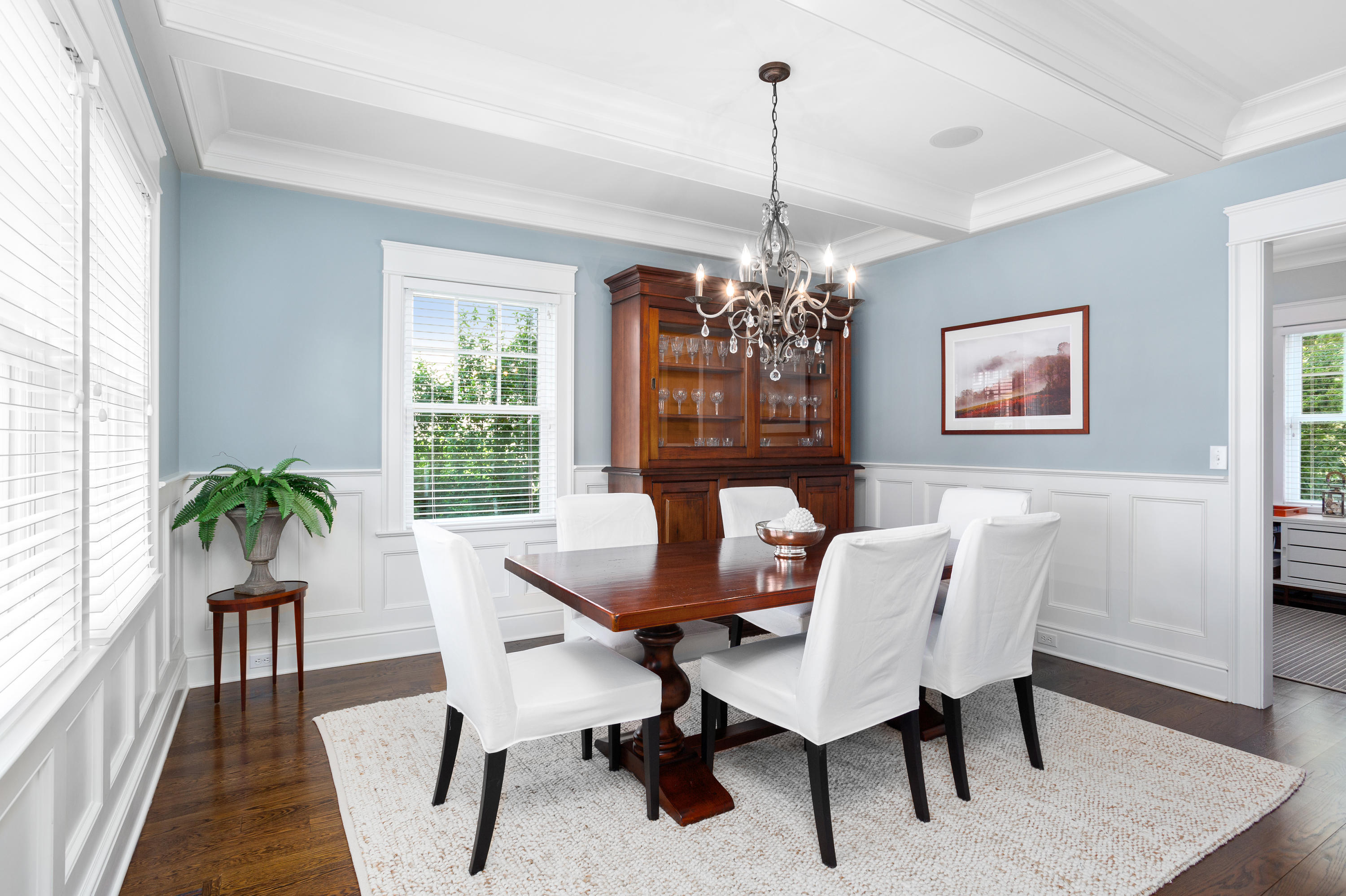9 Concord Lane Darien, CT 06820 - Photo 16 of 36 a dining room with furniture a chandelier and wooden floor
