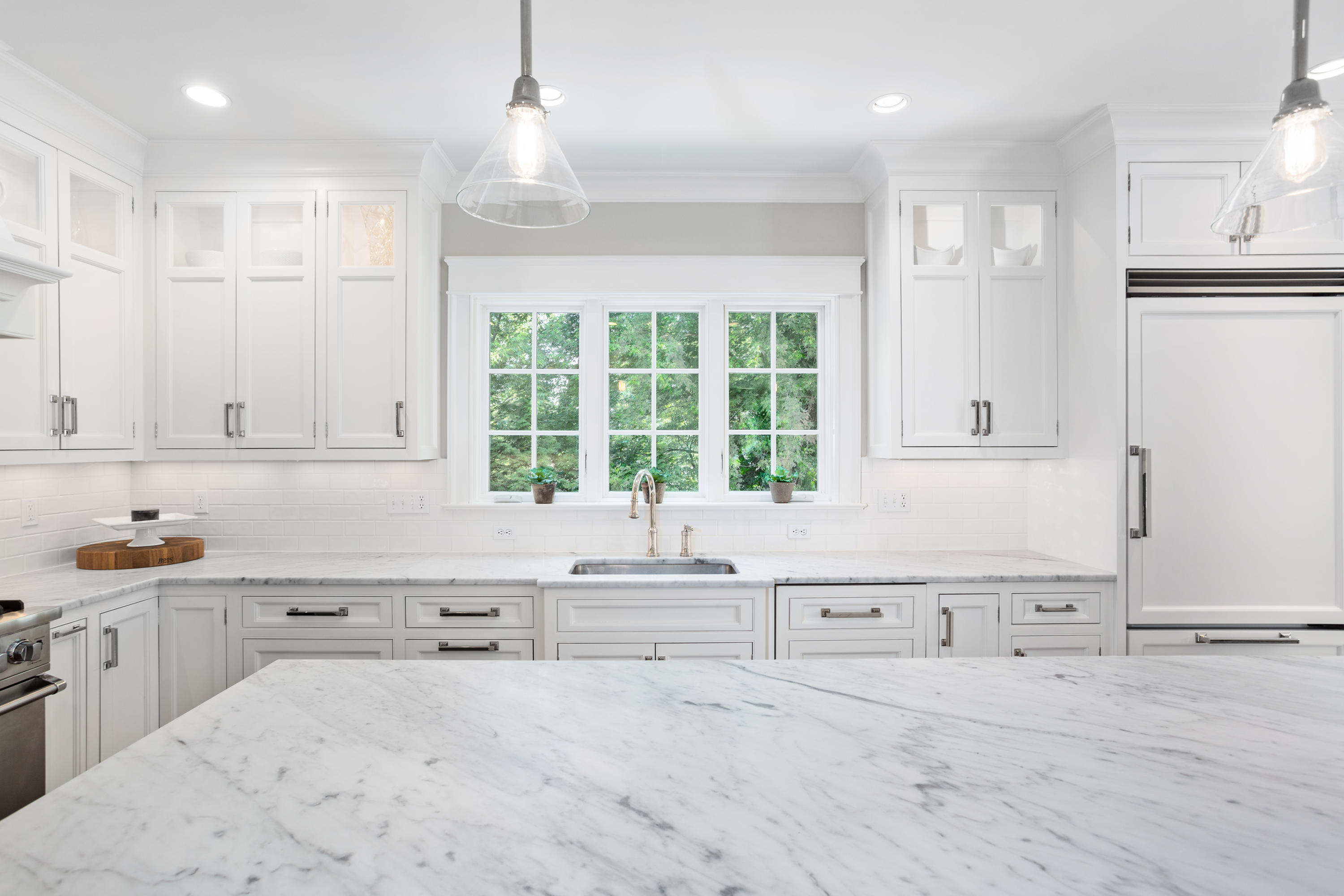 9 Concord Lane Darien, CT 06820 - Photo 9 of 36 a kitchen with granite countertop a sink and white cabinets