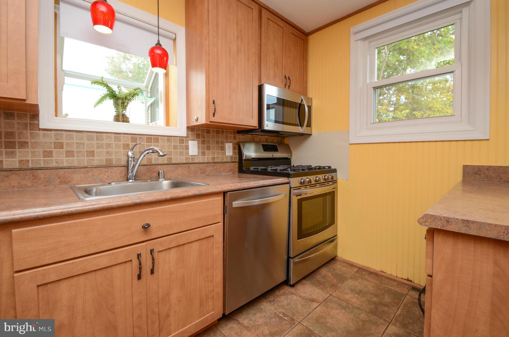 8107 Hillendale Road Baltimore, MD 21234 - Photo 6 of 30 a kitchen with stainless steel appliances white cabinets and a sink