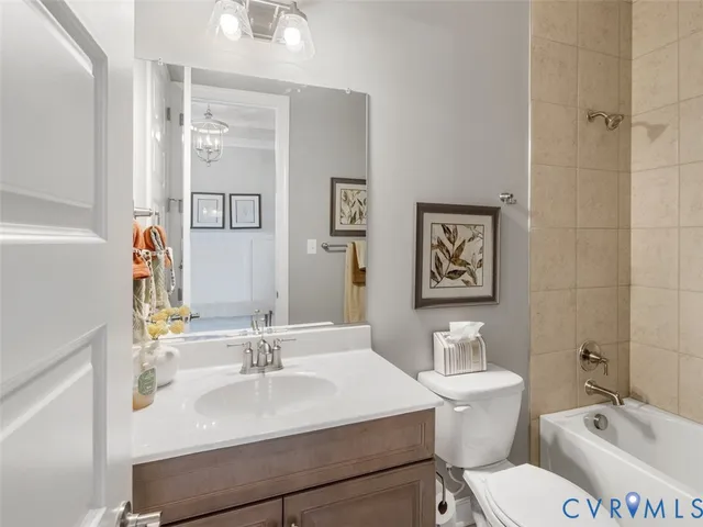 a bathroom with a sink vanity mirror and toilet