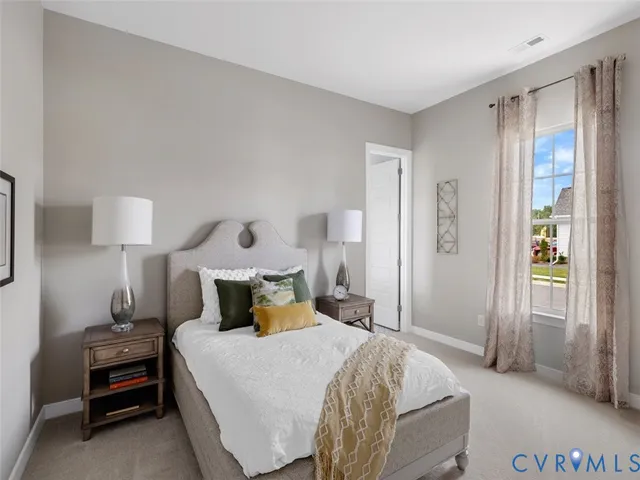 a bedroom with a bed and a lamp