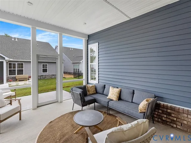 a balcony with furniture and a potted plant