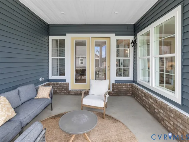 a balcony with furniture and a large window