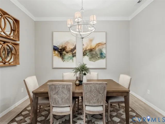 a dining room with furniture and chandelier