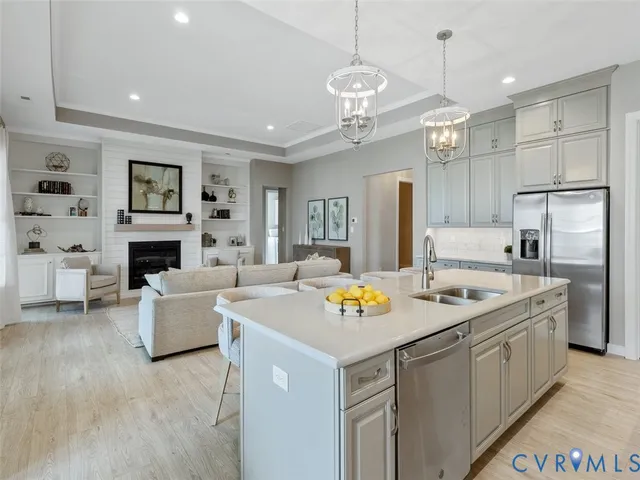 a kitchen that has a lot of cabinets in it and stainless steel appliances