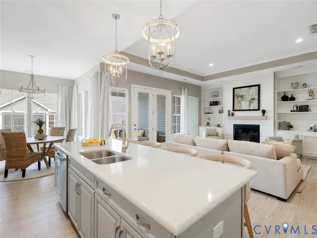 a living room with fireplace furniture and a chandelier