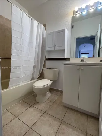 a bathroom with a toilet a sink and a mirror