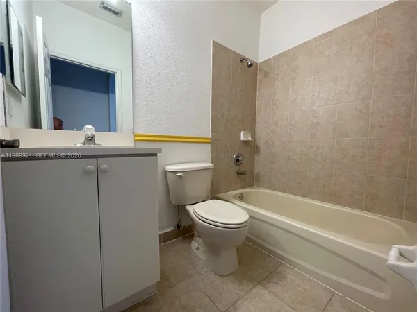a bathroom with a sink a toilet and bathtub