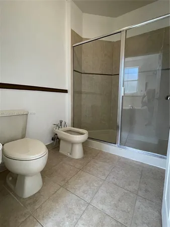 a bathroom with a toilet sink and shower