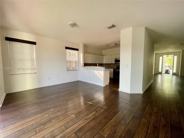 a view of a kitchen with a sink and a refrigerator