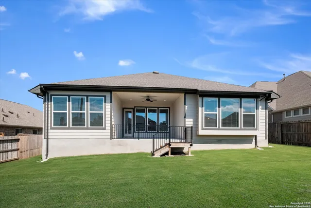 a view of a house with backyard porch and sitting area