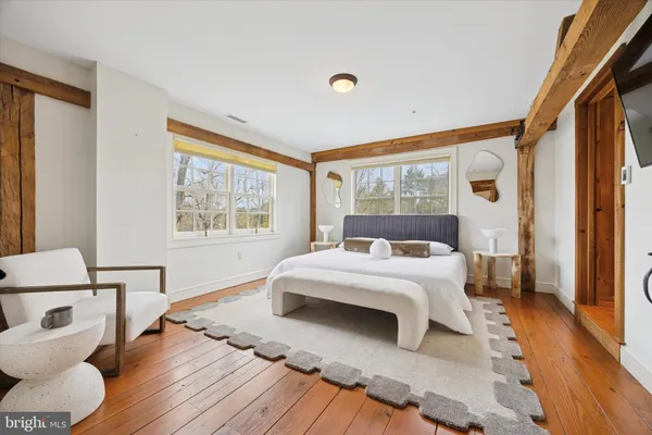 a bedroom with a large bed and a window