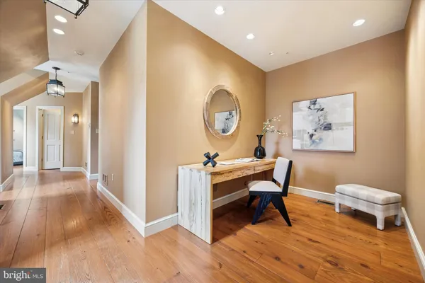 a view of a workspace with furniture and wooden floor