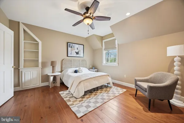 a bedroom with a bed and a chair