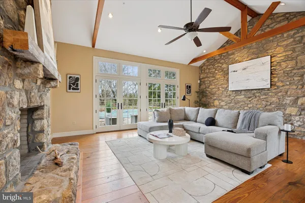 a living room with furniture a fireplace and a large window
