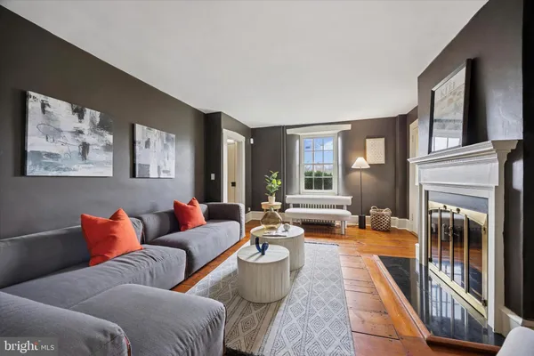 a living room with furniture and a fireplace