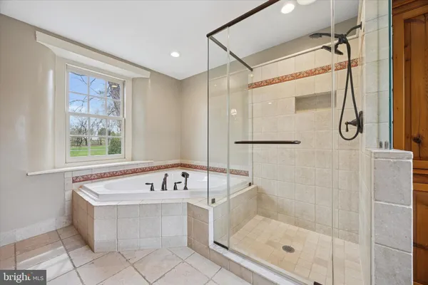 a bathroom with a bathtub and shower