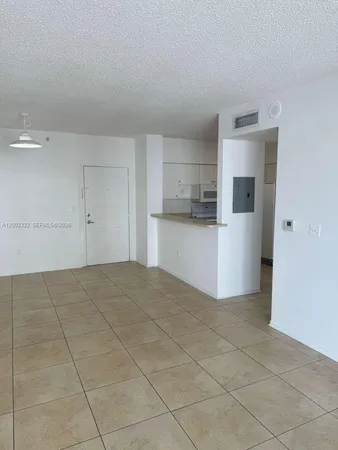 a view of a kitchen with a sink and a refrigerator