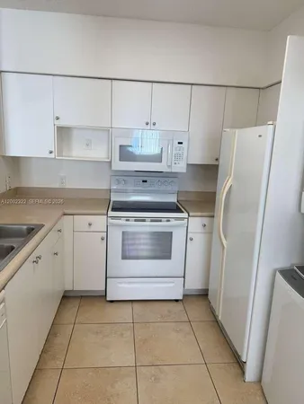 a kitchen with a stove sink and refrigerator