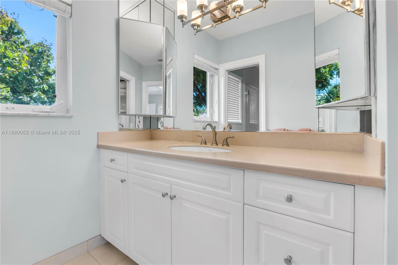 3921 Northeast 31st Avenue Lighthouse Point, FL 33064 - Photo 26 of 64 a bathroom with a sink and a mirror