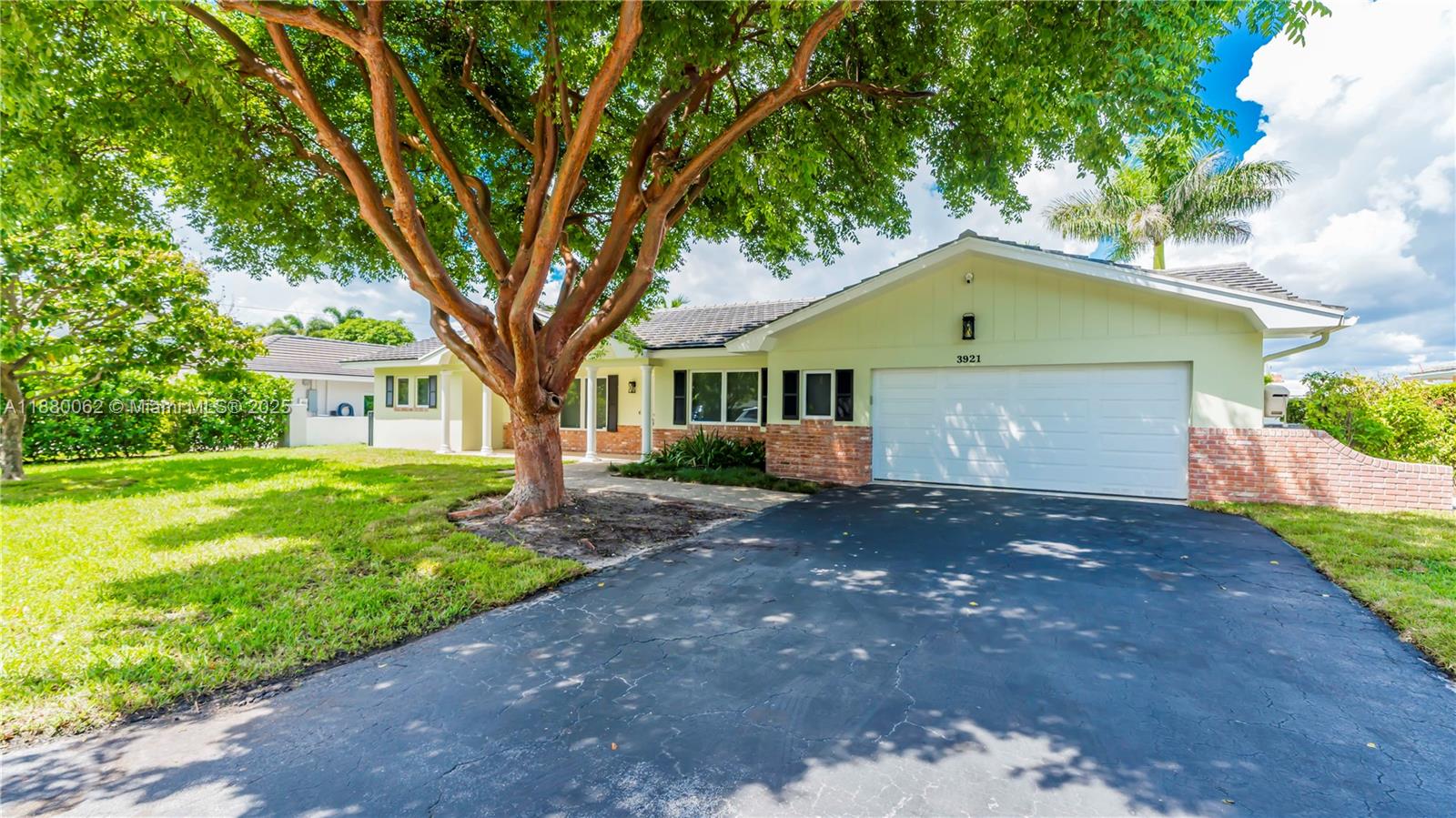 3921 Northeast 31st Avenue Lighthouse Point, FL 33064 - Photo 63 of 64 a front view of a house with yard and green space