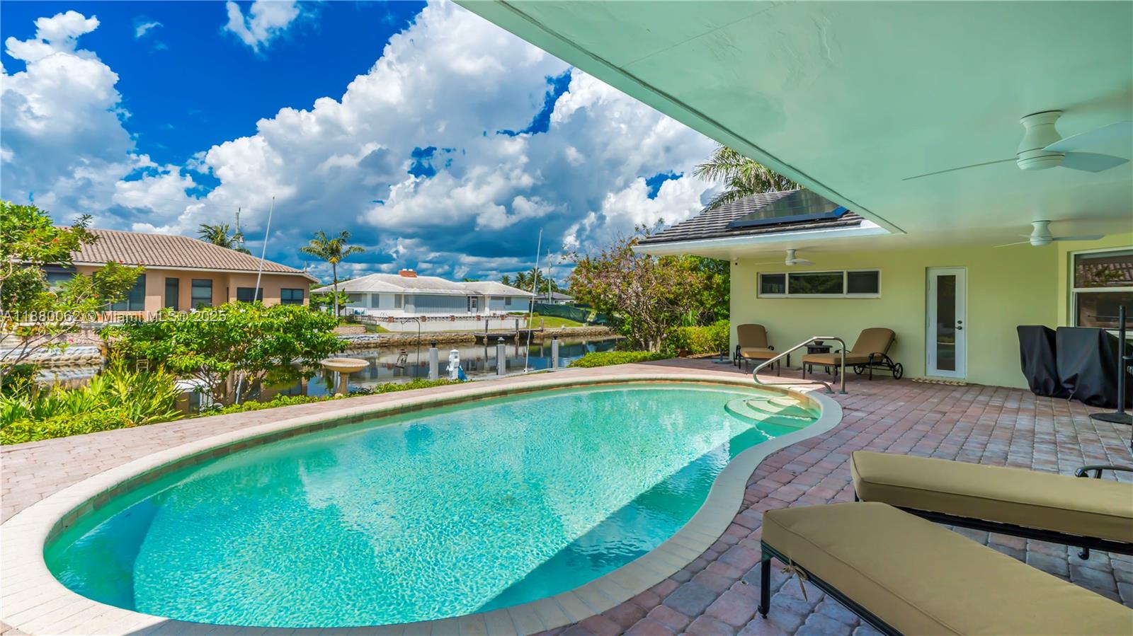 3921 Northeast 31st Avenue Lighthouse Point, FL 33064 - Photo 7 of 64 a swimming pool with outdoor seating and yard