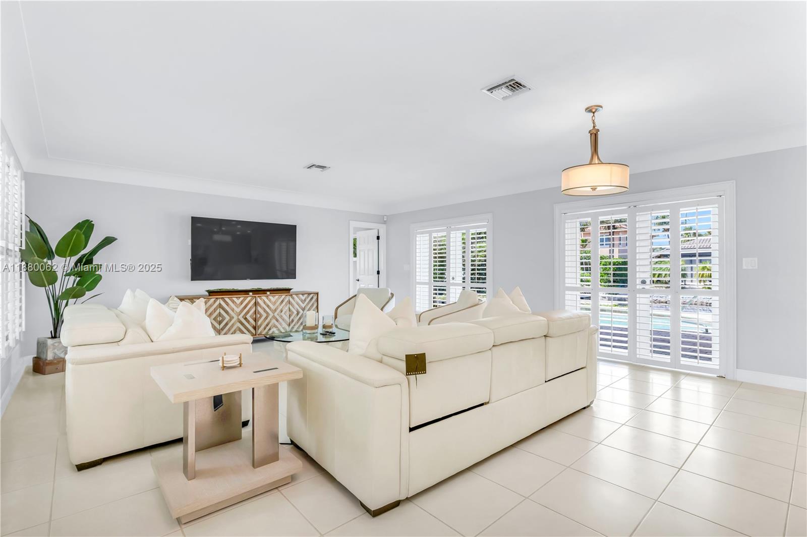 3921 Northeast 31st Avenue Lighthouse Point, FL 33064 - Photo 10 of 64 a living room with furniture and a flat screen tv